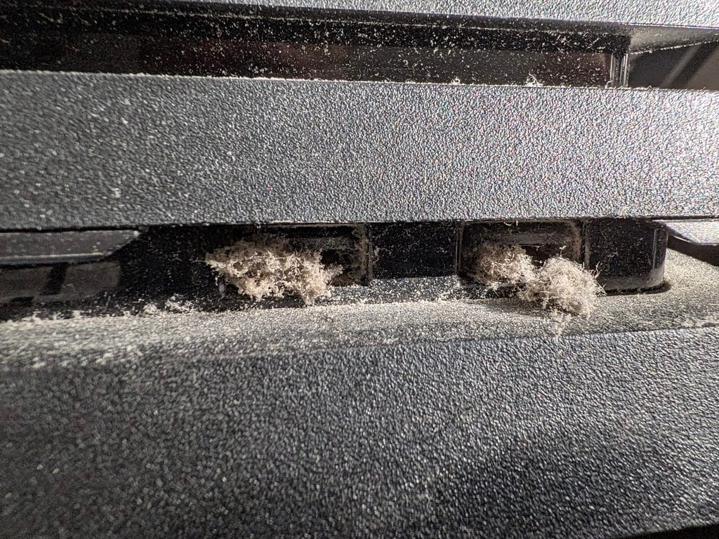 PS4 externally clogged and worse inside. These are the front USB ports and this is what we dragged out with fine tweezers.